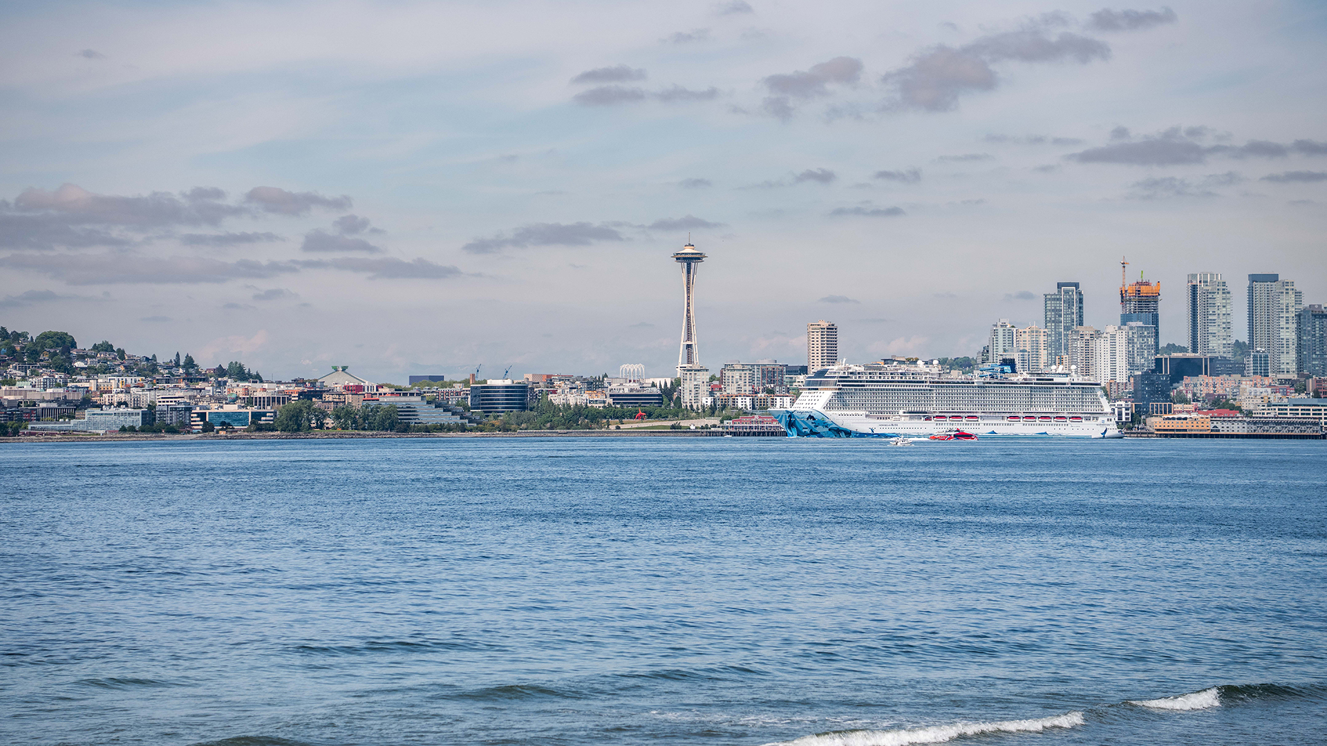 A view of the Seattle skyline over blue water.