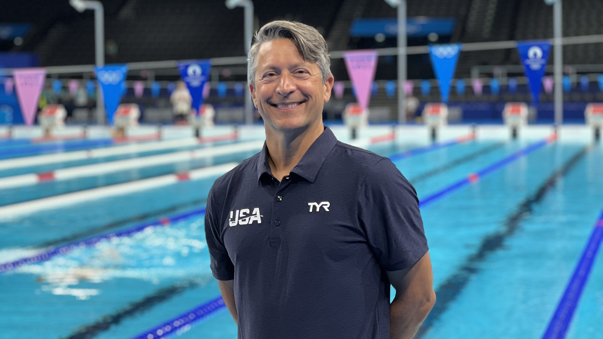 Brian Krabak, MD, stands in front of a pool.