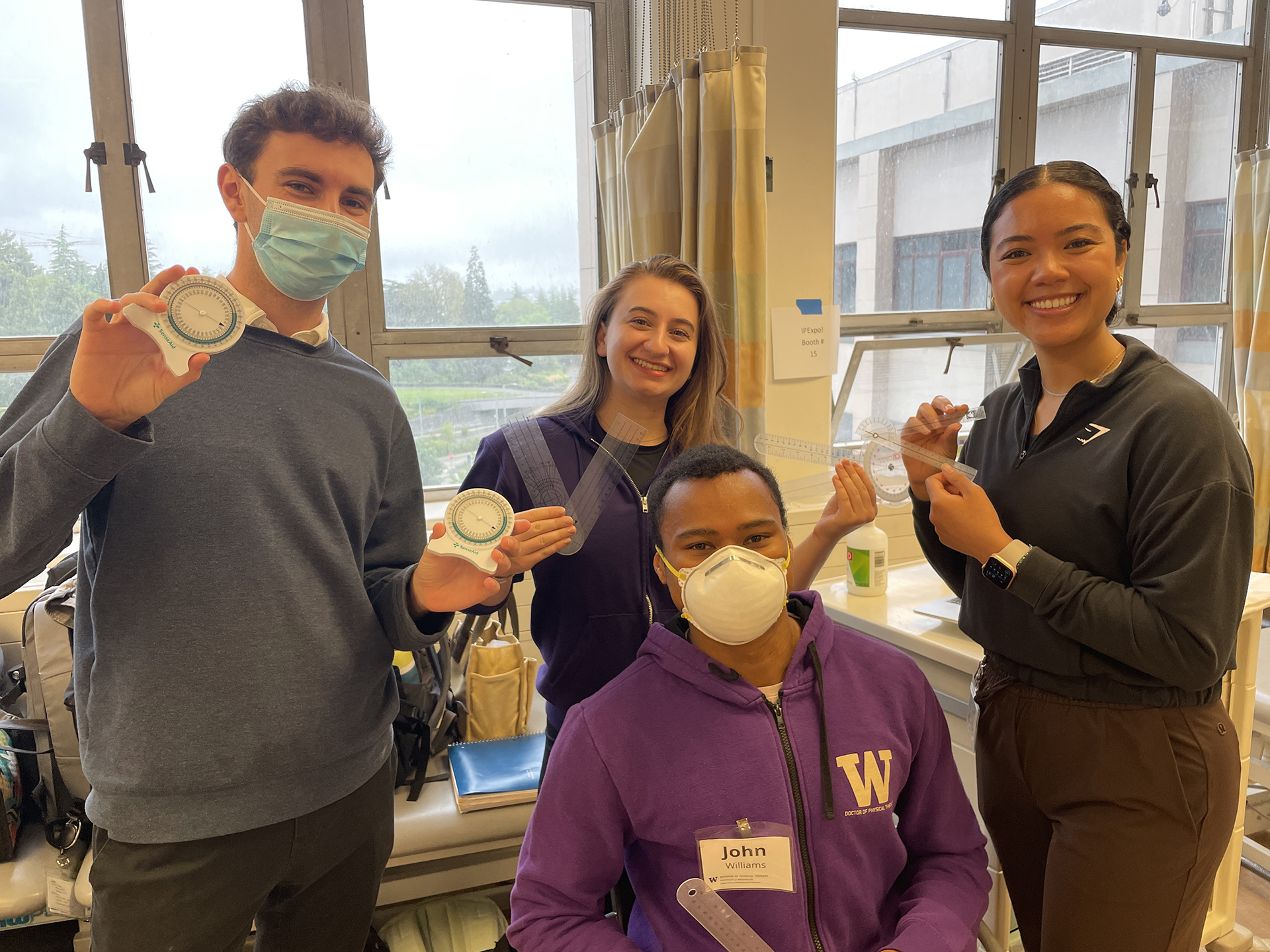 Students hold various measuring tools.