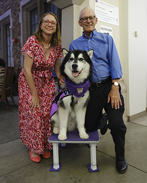 Janna Friedly, right, stands with Peter Esselman and Dubs, the UW's mascot and a very fluffy Alaskan Malamute.
