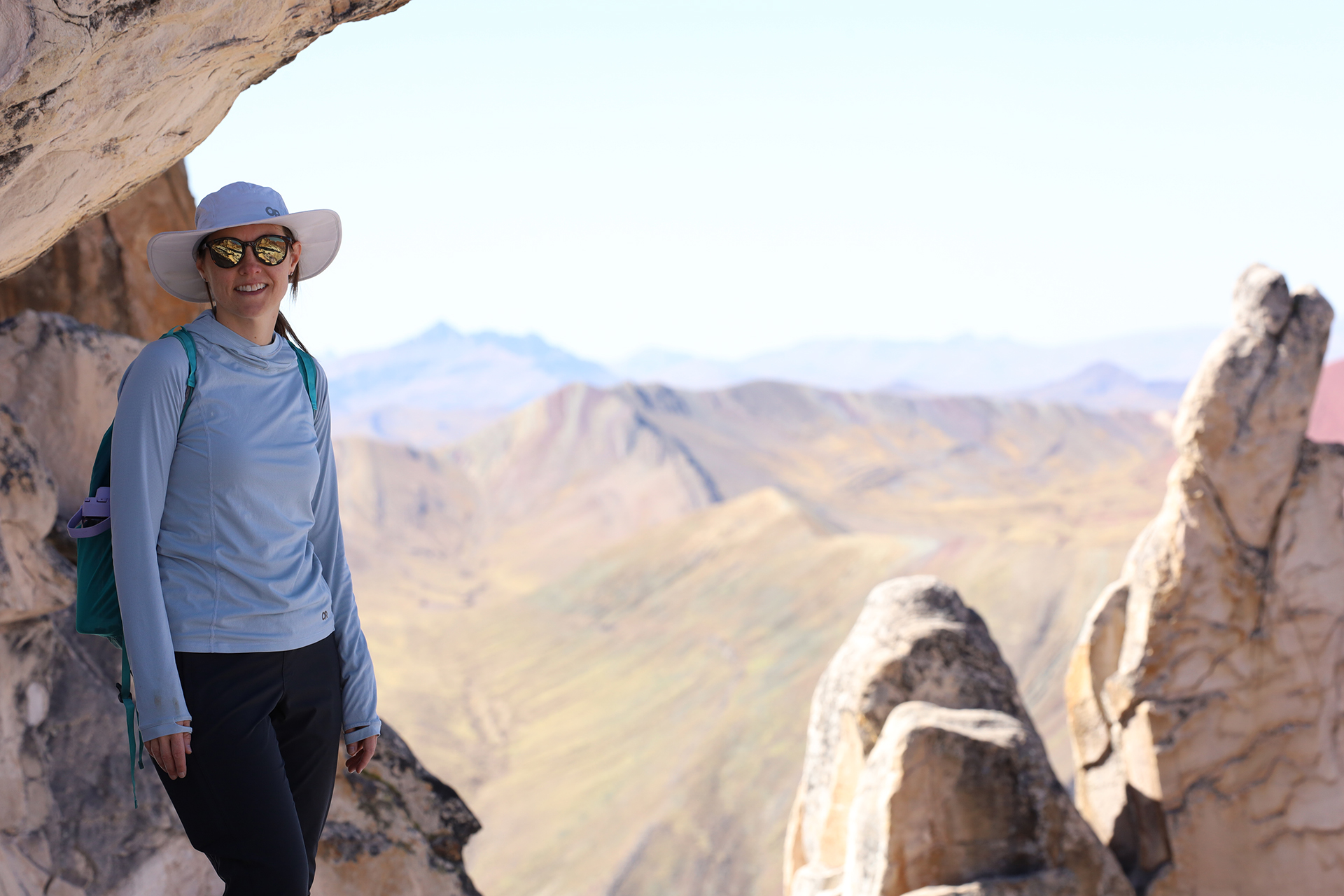 Dr. Loveless stands in front of a vista of desert mountains.