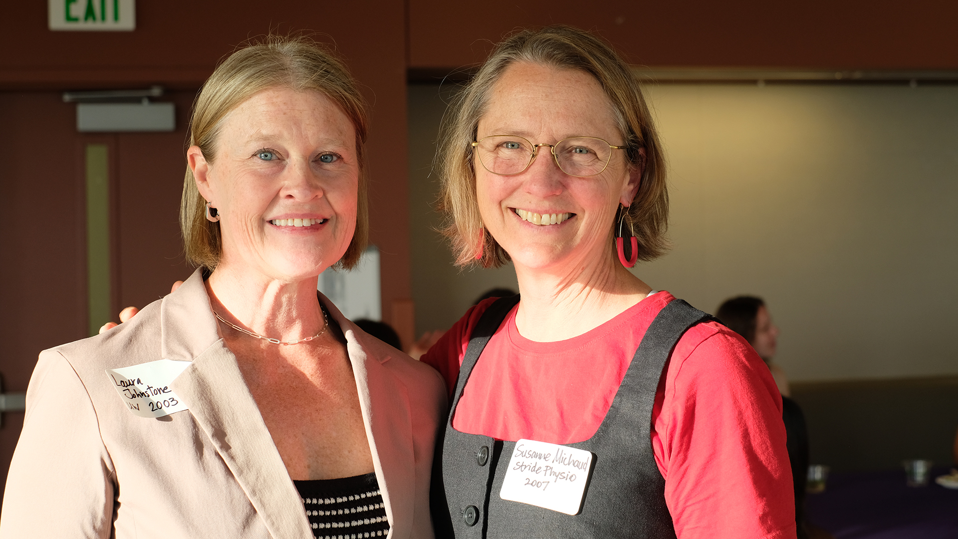 Two women smile at the camera.