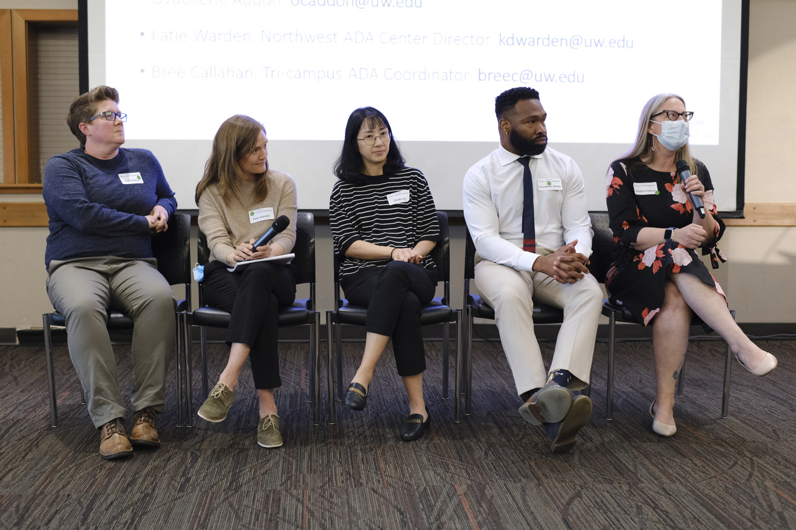 The panel sits, listening to a question