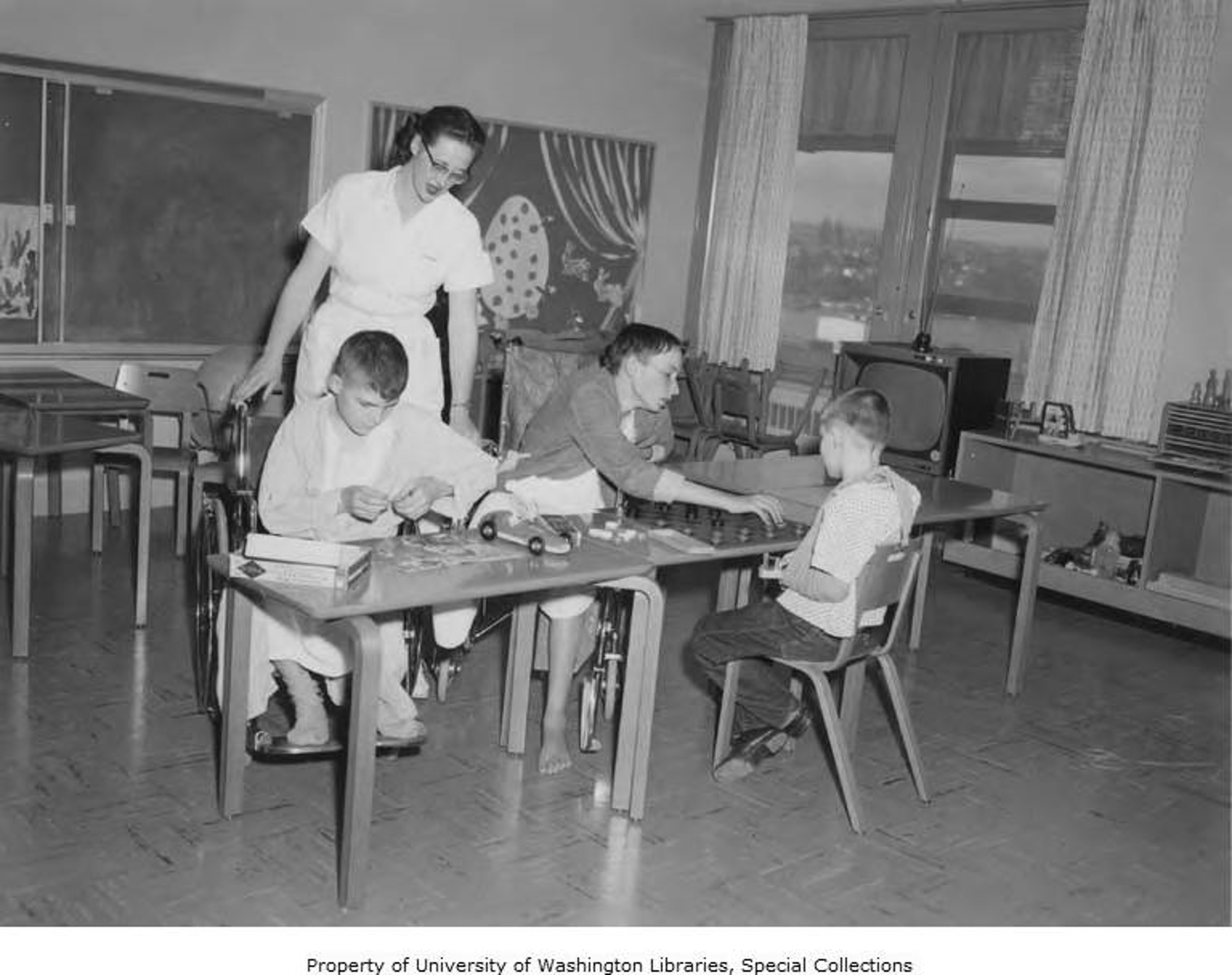 Woman conducting OT with three boys in the Children's Activity Room