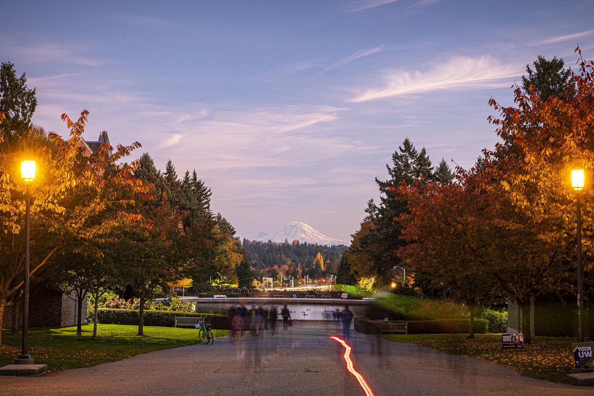A view of Mount Rainer above Drumheller Fountain on UW campus at dusk.