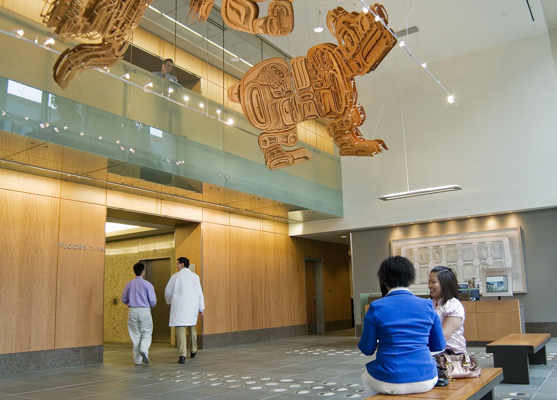 People walk through the lobby of the Ninth and Jefferson Building.