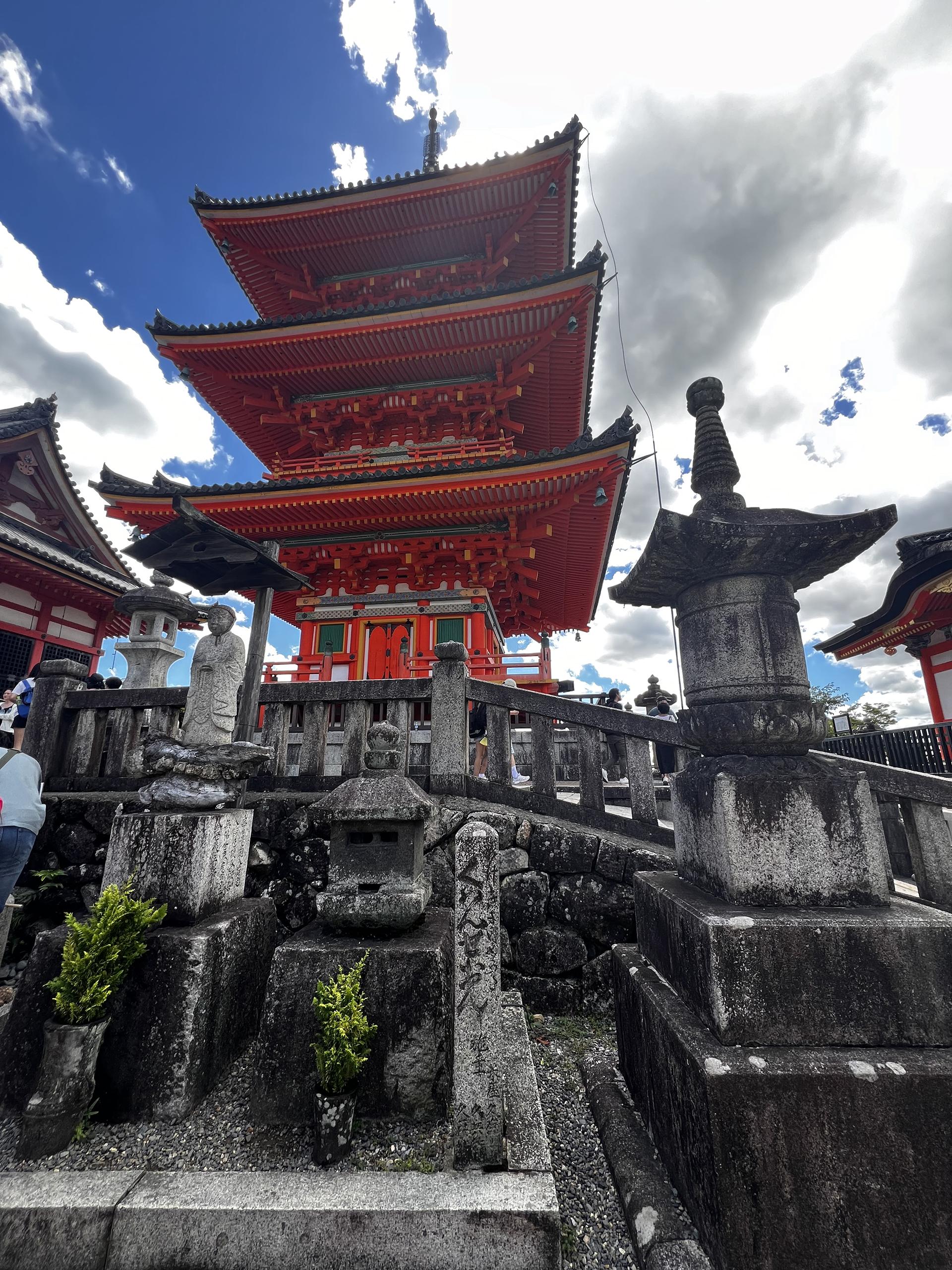 A Japanese shrine glows orange against a deep blue sky. 