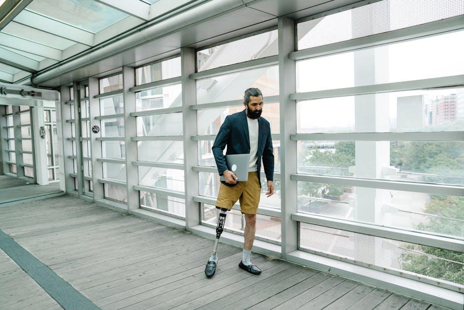 A man with lower limb prosthesis walking in a building. 