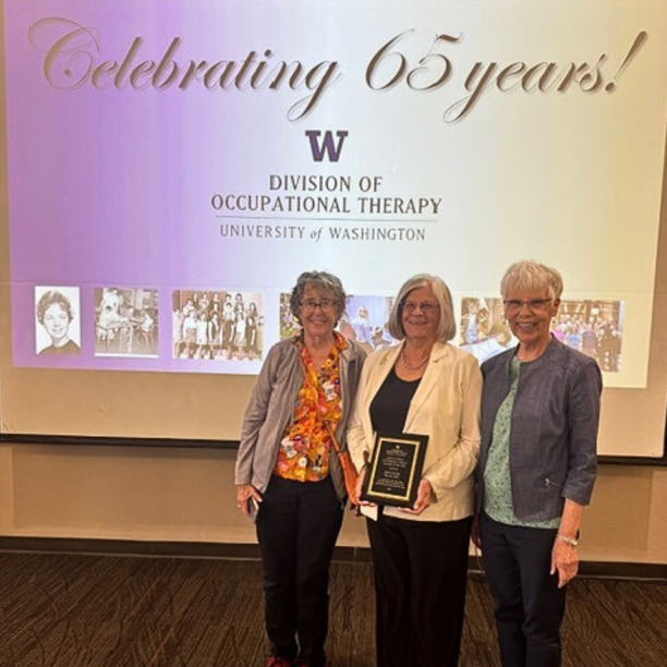 3 women in front of a Celebrating 65 years background