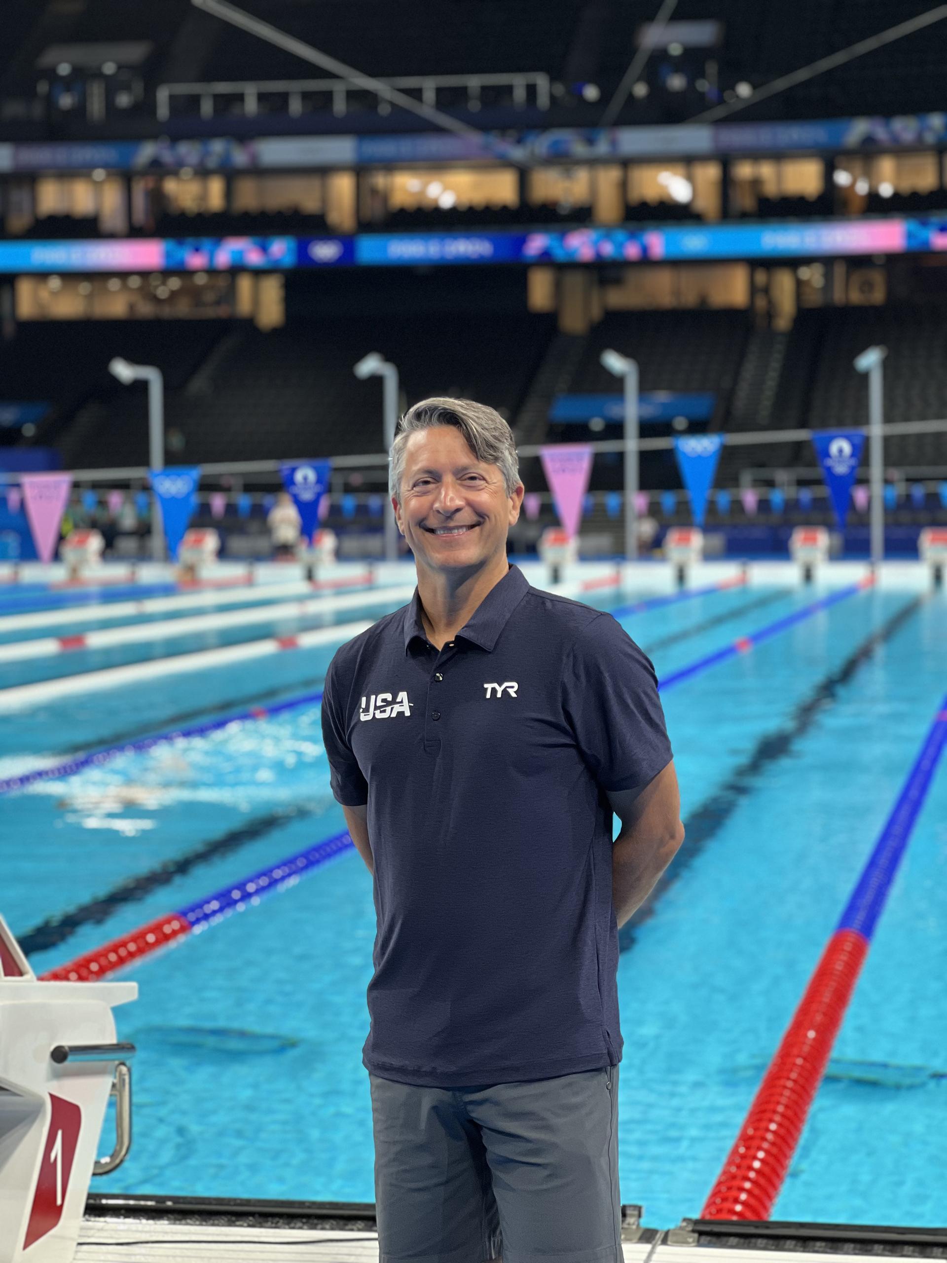 Brian Krabak stands in front of a pool. 