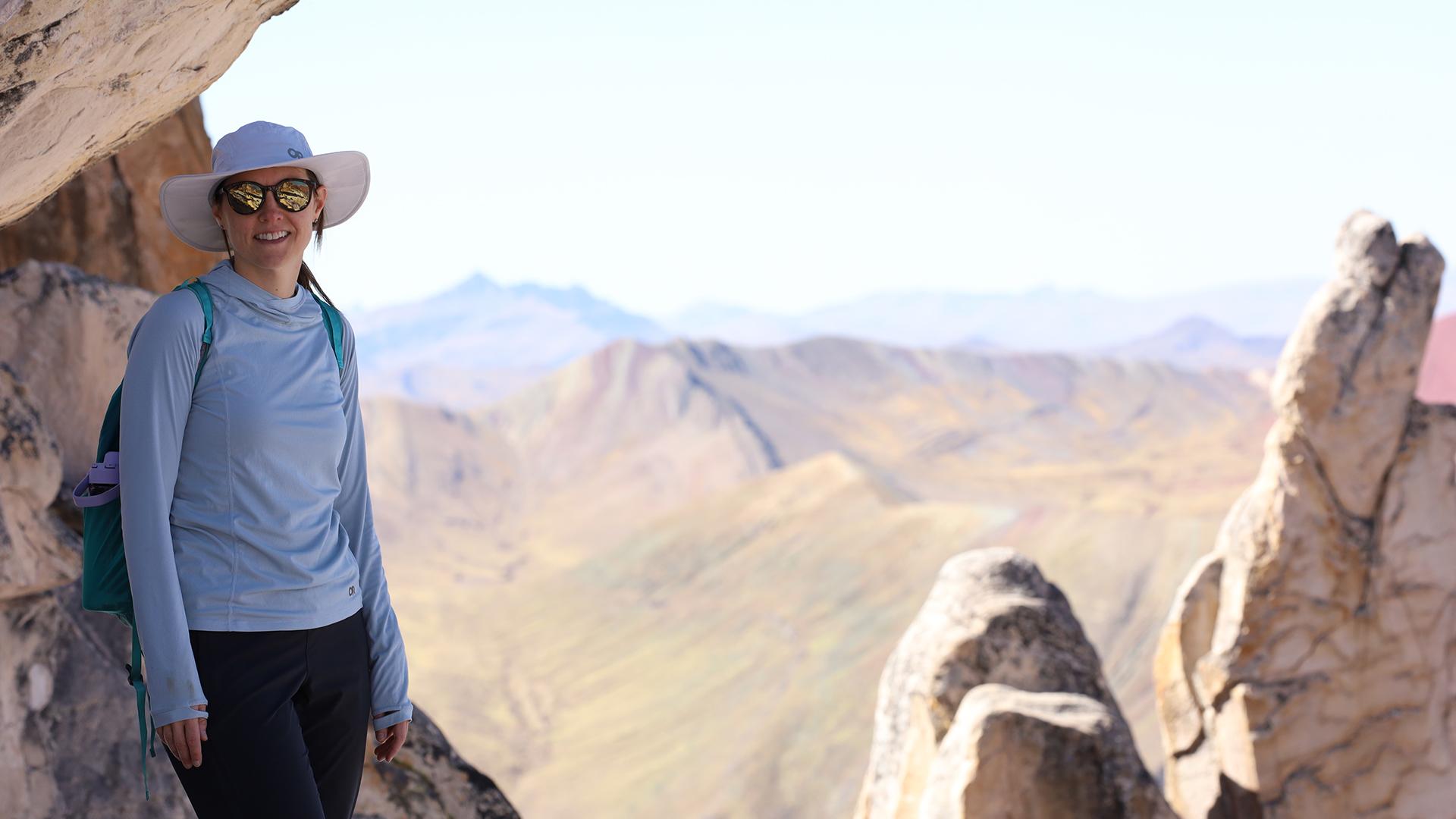 Dr. Loveless stands in front of a vista of desert mountains. 