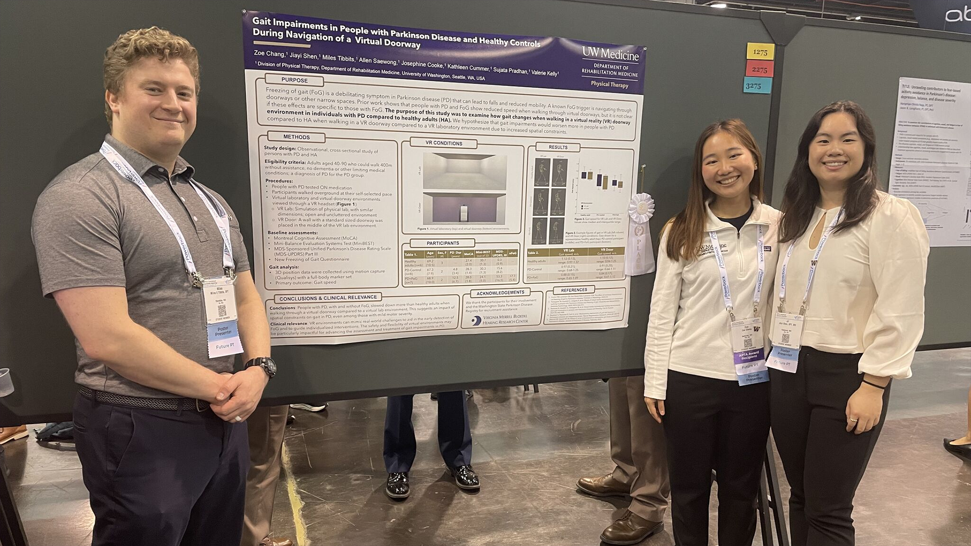 Three people stand in front of an academic poster. 
