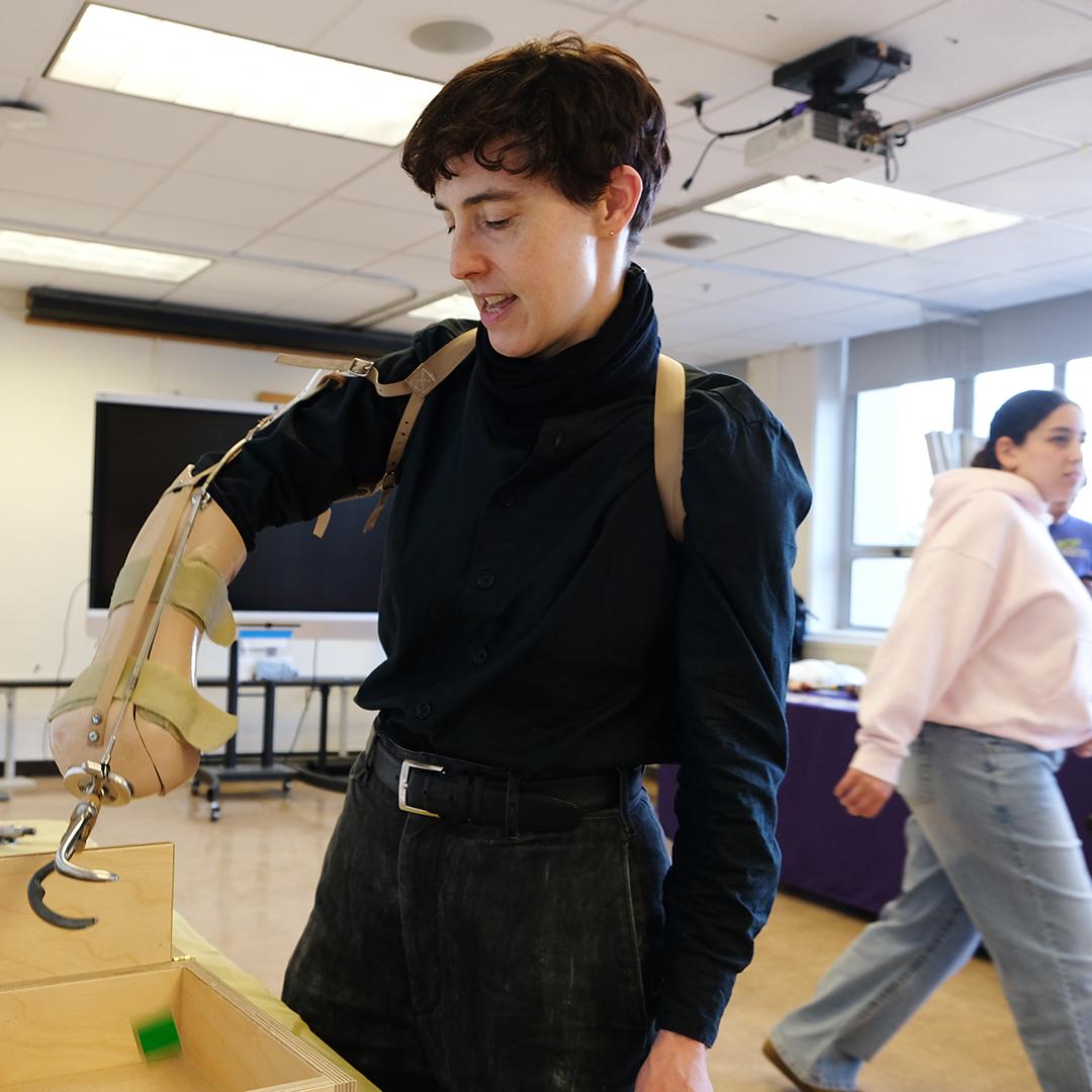 A person wearing a lower arm prosthetic fitted with a hook.