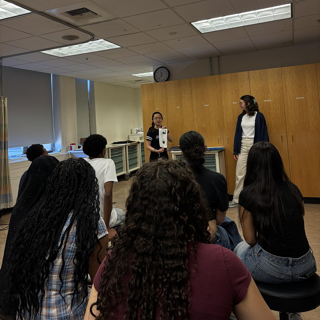 Students watch a demo of how to take footprint impressions.