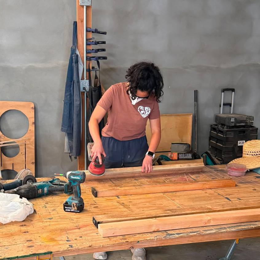 A woman working in a woodshop.